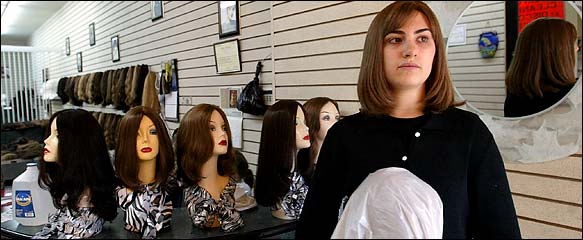 Celine Schonberger, 19, wears an approved wig at a store in Brooklyn. Some Orthodox rabbis have barred human-hair wigs from India.